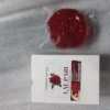 Red rose-shaped soap placed next to its packaging listing benefits for skin care.